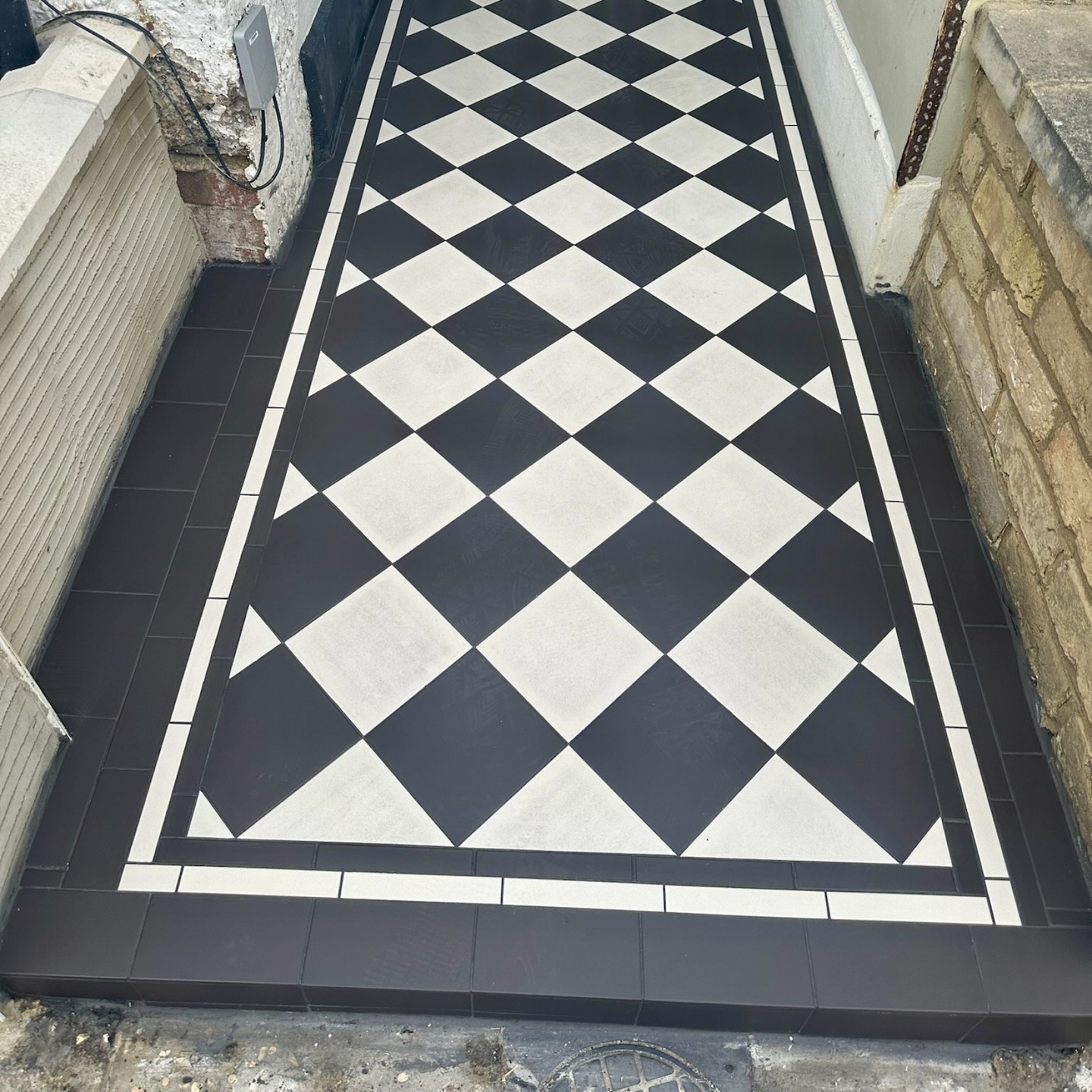 Victorian style tiled path with anthracite pavers installed at a terraced house in Twickenham
