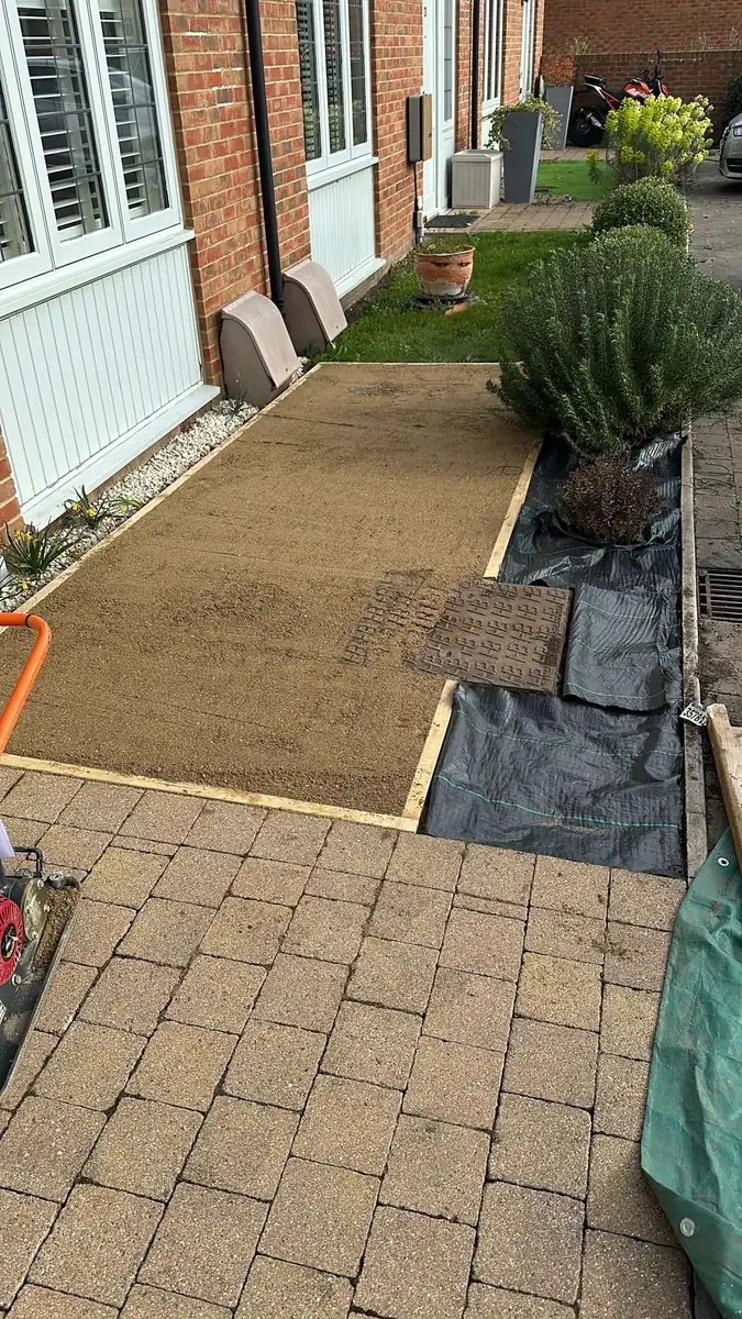 Levelled sand base inside timber edging, with membrane laid for the chipping beds
