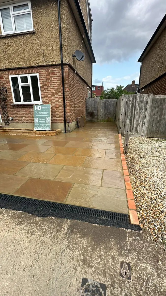 Side view of the widened sandstone driveway running back alongside the house in Surbiton