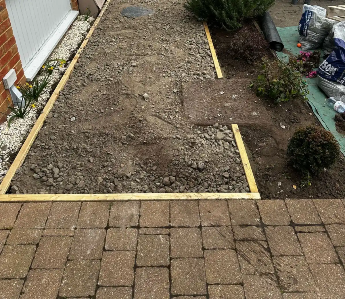 The old front lawn dug out inside a new timber edging frame in Bookham