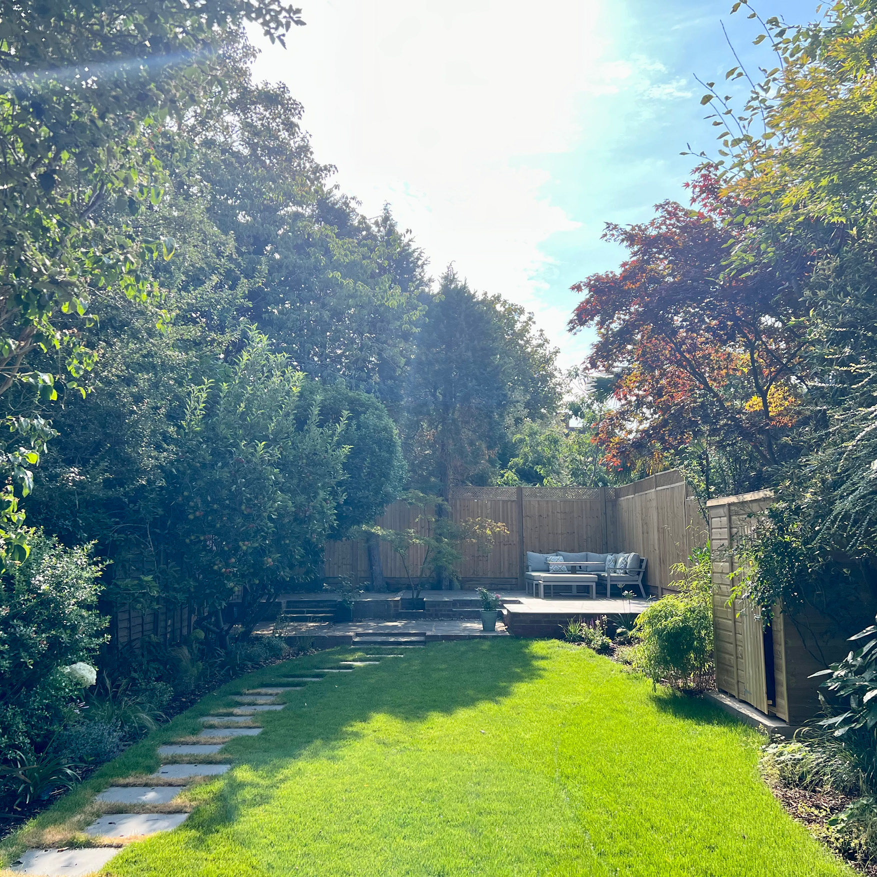 Completed East Molesey garden transformation with composite decking, stepping stone path, new lawn and fencing