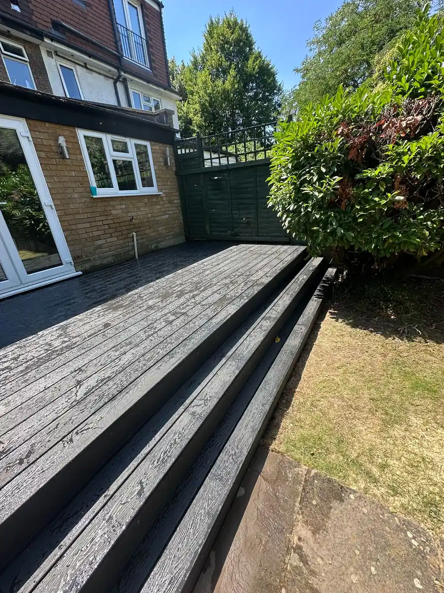 Full width composite decking steps down to the garden, Teddington
