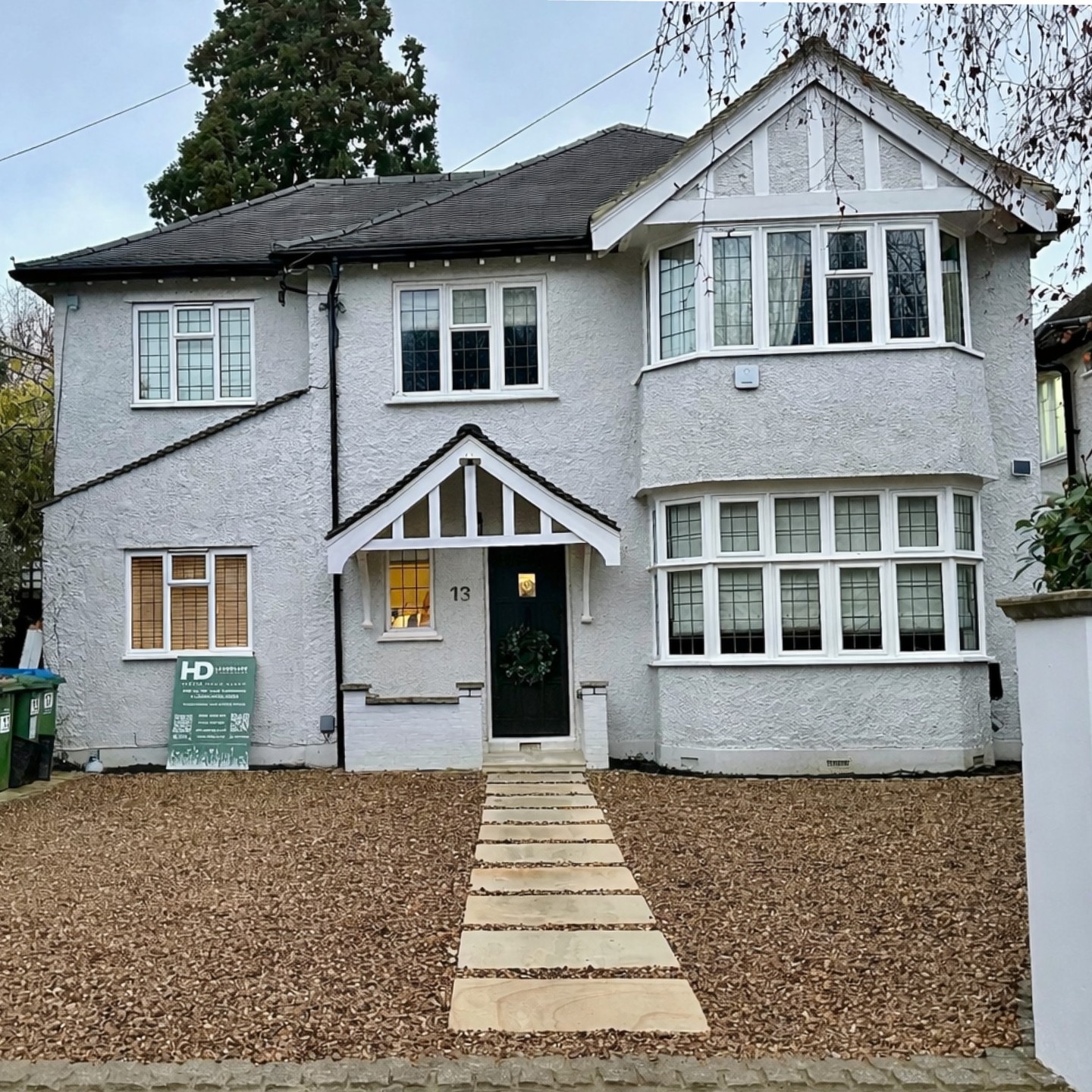 Gravel driveway with sandstone stepping path leading to the front door of a 1930s home in East Molesey, Surrey