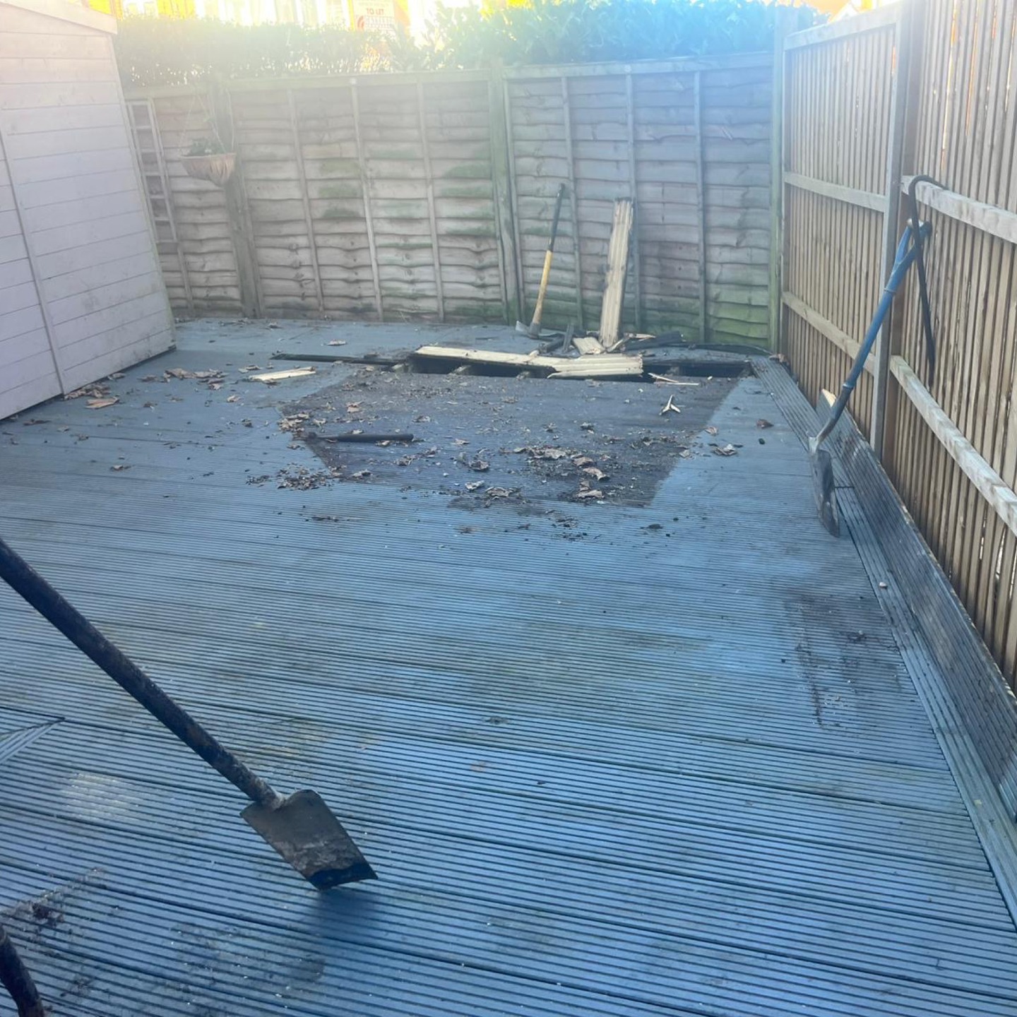 Before: old damaged decking covering the garden in Kingston upon Thames
